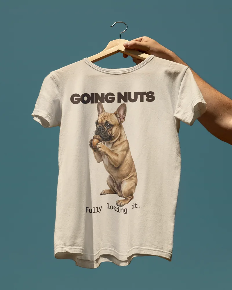 A tee printed with GOING NUTS and a French Bulldog holding a nut.